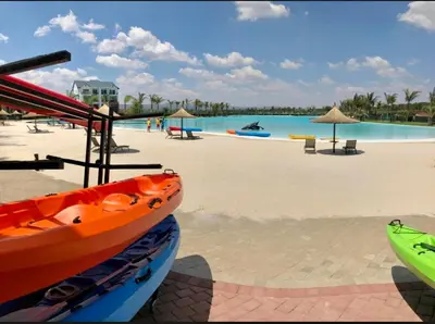 a boat sitting on the beach next to a pool at Beach-Style Bliss at The Blyde in Pretoria