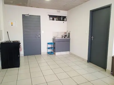 a kitchen with two doors and a tile floor at Patio Executive in Midrand