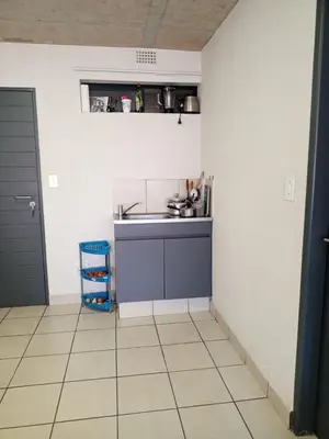 a small kitchen with a sink and a counter at Patio Executive in Midrand