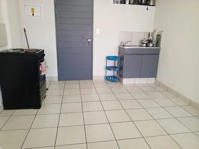 a kitchen with a door and a tiled floor at Patio Executive in Midrand
