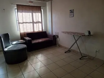 a living room with a couch and a table at Patio Executive in Midrand