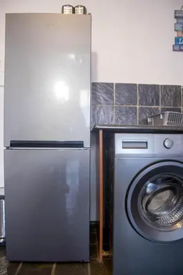 a kitchen with a refrigerator and a washing machine at Midrand Cozy in Midrand