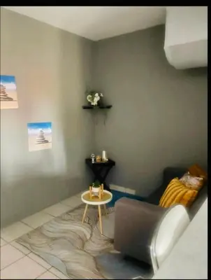 a living room with a couch and a table at Rekganya Sunset Lodge in Phalaborwa
