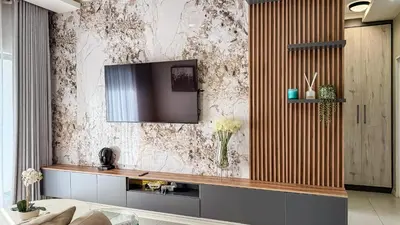 a living room with a television on a wall at Thetan's Home Away From Home in Midrand
