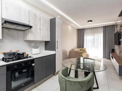 a kitchen with a glass table and a stove at Thetan's Home Away From Home in Midrand