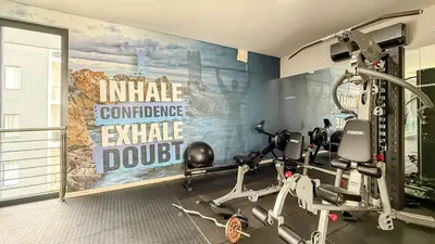 a fitness room with a gym with a treadmill at Thetan's Home Away From Home in Midrand