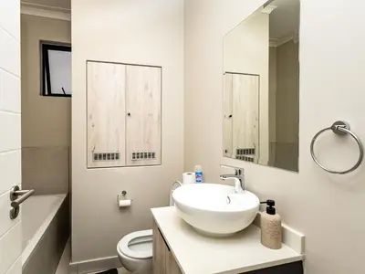a bathroom with a sink and a toilet at Thetan's Home Away From Home in Midrand