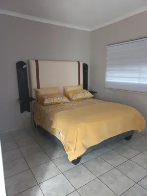 a bedroom with a bed with a yellow blanket on it at House at Bethesda in Springs