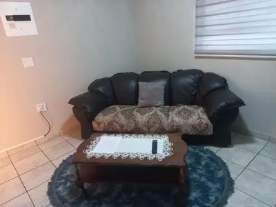 a leather couch in a living room with a coffee table at House at Bethesda in Springs