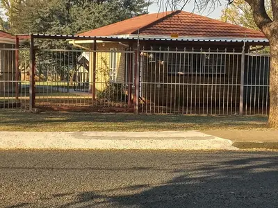 a gate in front of a building with a playground at House at Bethesda in Springs