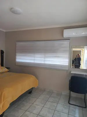 a bedroom with a window with a window blind at House at Bethesda in Springs