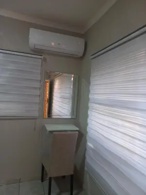 a room with a window with blinds and a chair at House at Bethesda in Springs