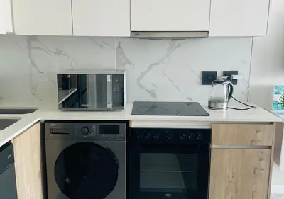 a kitchen with a microwave and a stove top oven at Cozy Apartment at The Blyde in Pretoria