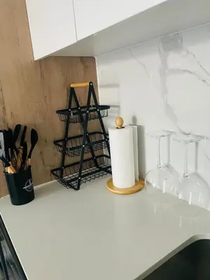a kitchen counter with two wine glasses on it at Cozy Apartment at The Blyde in Pretoria