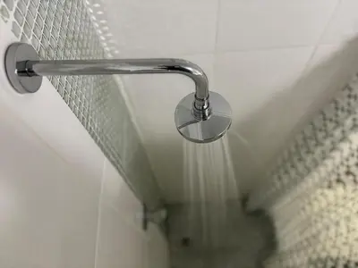 a shower head on a wall in a bathroom at Load shedding free studio apartment in Pretoria