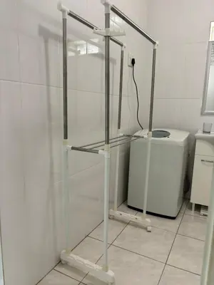 a glass shelf in a bathroom with a washing machine at Load shedding free studio apartment in Pretoria