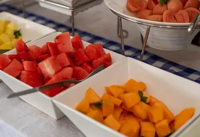 a bunch of fruits in white bowls on a table at Graskop Hotel in Graskop