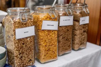 four jars of granola sitting on a table at Graskop Hotel in Graskop