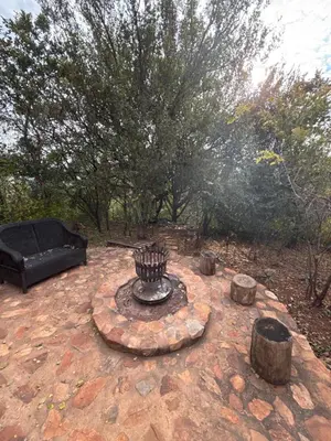a fire pit in the middle of a yard at Goldeneye Chalet -Hidden Gem of Hartees in Hartbeespoort
