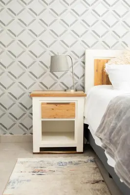 a bedside table with a lamp next to a bed at The African Penguin Guesthouse in Pretoria