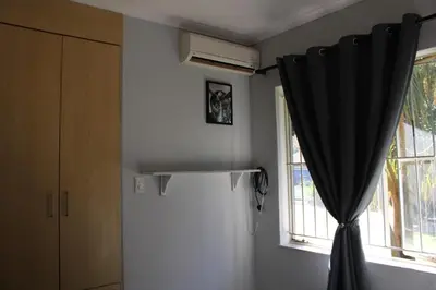 a room with a black curtain and a window at Blue Orchid in Midrand