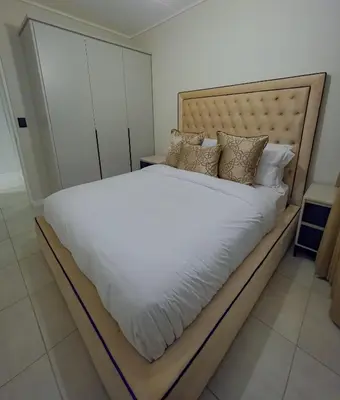 a bedroom with a large bed with white sheets and pillows at The Blyde 3bed Beach Facing F&S Luxurious 2 in Pretoria