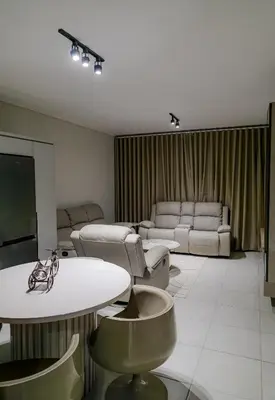 a living room with couches and a table and chairs at The Blyde 3bed Beach Facing F&S Luxurious 2 in Pretoria