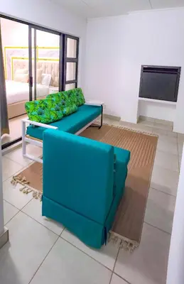 a living room with a blue couch and a tv at The Blyde 3bed Beach Facing F&S Luxurious 2 in Pretoria