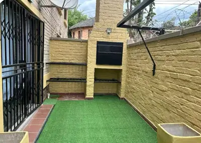 a patio with green grass next to a building at 4beds,3 bedrooms,Braai,Full kitchen in Tzaneen