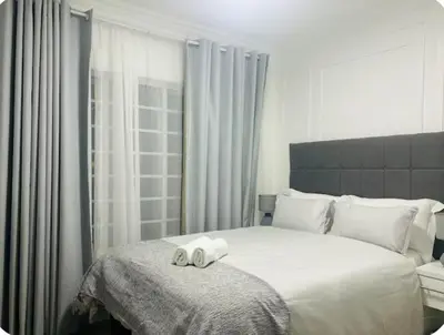 a bedroom with a bed with two towels on it at 4beds,3 bedrooms,Braai,Full kitchen in Tzaneen