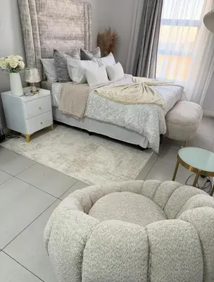 a bedroom with a bed and a couch and a table at 273OnNew Road in Midrand