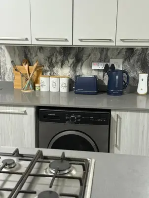 a kitchen counter with a stove and a dishwasher at 273OnNew Road in Midrand