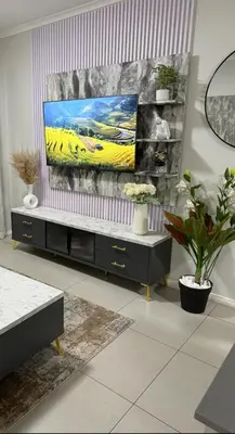 a living room with a tv on a stand at 273OnNew Road in Midrand