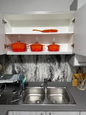 three pots on a shelf above a kitchen sink at 273OnNew Road in Midrand