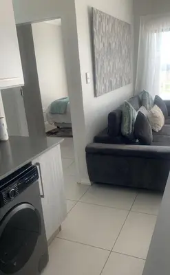 a living room with a couch with pillows on it at 273OnNew Road in Midrand