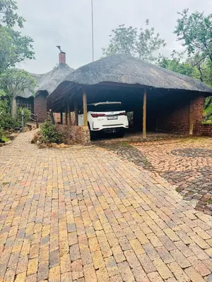 a car parked in a garage with a roof at Mabalingwe Mistykie Lodge in Warmbaths