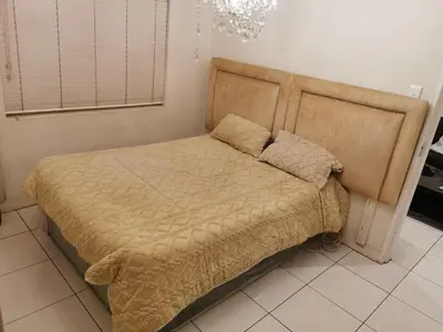 a bedroom with a bed with a headboard at sleepwell inn in Midrand