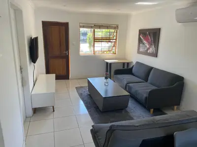a living room with a couch and a coffee table at sleepwell inn in Midrand