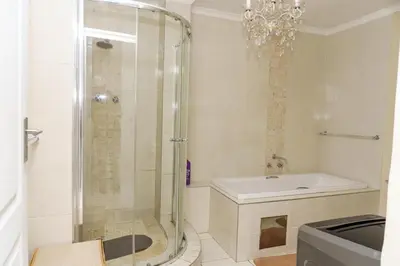 a bathroom with a shower and a sink at sleepwell inn in Midrand