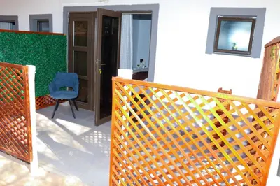 a wooden fence in a room with a chair at Remi's Boutique Lodge & SPA in Pretoria