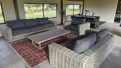 a living room with couches and a table and a piano at Die Pekanneut in Polokwane