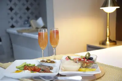 a plate of food and two glasses of champagne at The Village GuestHouse in Acornhoek