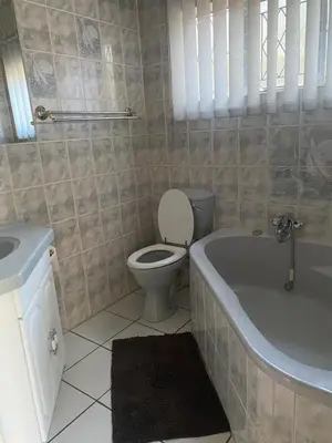 a bathroom with a toilet and a tub and a sink at Lynnwood 246 House in Pretoria
