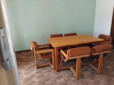 a wooden table and chairs in a room at Lynnwood 246 House in Pretoria