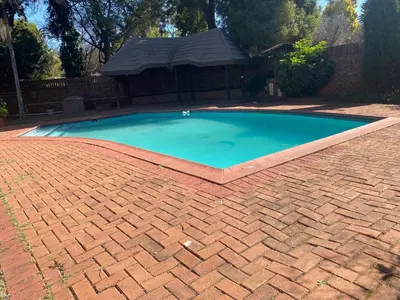 a brick pool in a yard with a brick driveway at Lynnwood 246 House in Pretoria