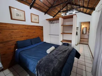 a bedroom with a blue bed in a room at Thaba Bolayi Private Nature Reserve in Musina