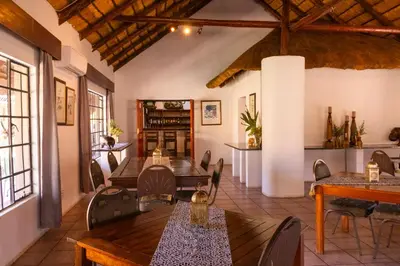 a restaurant with tables and chairs in a room at Thaba Bolayi Private Nature Reserve in Musina