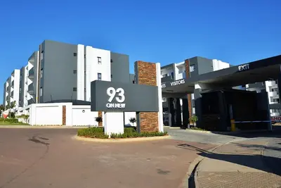 a building with a sign that reads current at Eirini Elegant Hades Apartment in Midrand