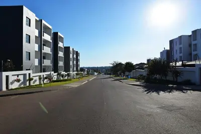 an empty street in a city with tall buildings at Eirini Elegant Hades Apartment in Midrand