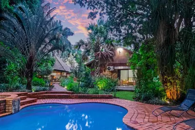 a house with a swimming pool in the yard at Spurflower in Tzaneen